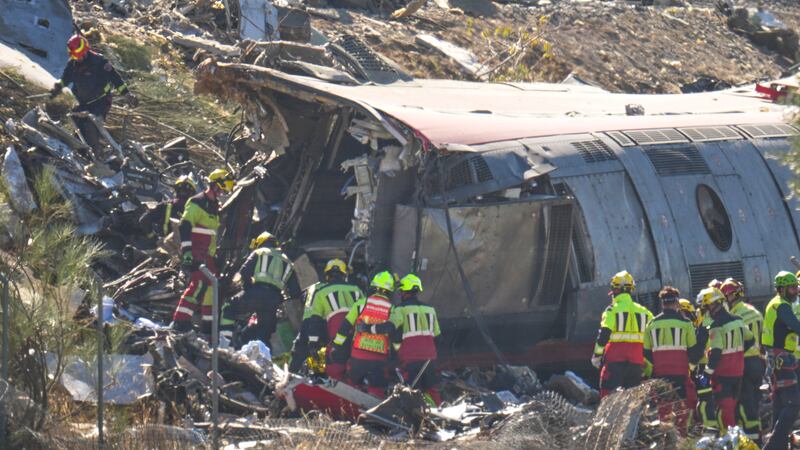 Emergency services work at the scene of a collision between two trains in Urda, Spain,...