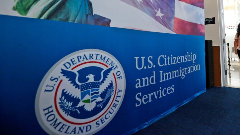 FILE - In this Aug. 17, 2018, file photo, people arrive before the start of a naturalization...