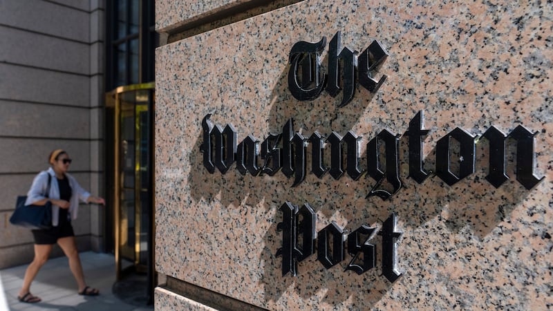 FILE - A person walks into the One Franklin Square Building, home of The Washington Post...