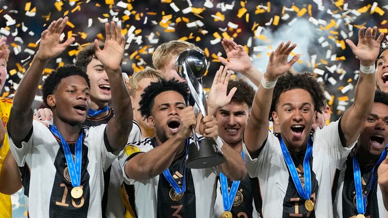 Almugera Kabar (centro) alza el trofeo de campeones luego de la victoria de Alemania ante...